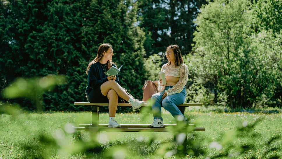 Deux jeunes femmes qui discutent à l'extérieur